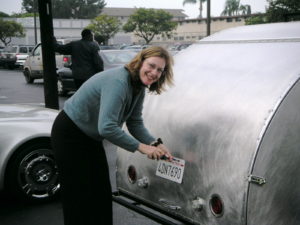 Louise installs the 2nd half of the new license plate - because we like to share in our fun! :-)